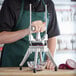 A person using a Global Solutions vegetable dicer to chop onions.