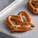 A close up of a J & J SuperPretzel on a baking sheet.