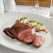 A plate with a Warrington Farm Meats sirloin steak on a table.