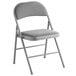 A grey folding chair with a gray cushion.