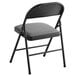 A black folding chair with a grey cushion.