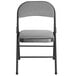 a black folding chair with grey cushion