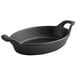 A black oval cast iron pan with handles.