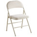 A beige folding chair with a padded cushion.
