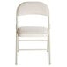 A beige folding chair with a padded seat.