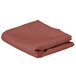 A folded mauve rectangular cloth table cover.