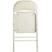 A beige folding chair with a padded seat.