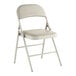 A beige vinyl folding chair with a padded seat and backrest.