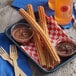 churros on a tray with chocolate sauce