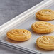 A tray of J & J Snack Foods Hola Churros churro sandwich buns on a gray surface.
