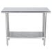 An Advance Tabco stainless steel work table with a shelf.