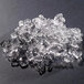 A pile of flake ice from a Hoshizaki water cooled ice machine on a black surface.