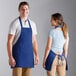 A man and woman wearing Choice royal blue aprons.