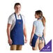 A man and woman wearing royal blue Choice restaurant aprons.