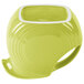 A Fiesta Lemongrass pitcher with a green liquid and a yellow mug.
