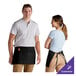 A man and woman wearing black customizable poly-cotton aprons with three pockets.