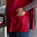 A woman wearing a red Choice cobbler apron.