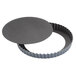 A round black Matfer Bourgeat tart pan with a removable bottom.