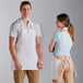 A man and woman standing next to each other wearing white Choice aprons.