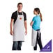 A person wearing a white Choice customizable apron.