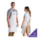 A man and woman wearing white Choice customizable bib aprons.