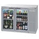 A Beverage-Air stainless steel back bar refrigerator with a glass door filled with bottles of beer.