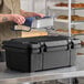 A black top-loading insulated food pan carrier designed to hold a 6-inch deep full-size pan.