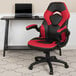 A red and black Flash Furniture office chair with a black laptop on the seat.