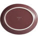 A red oval porcelain platter with a white border.