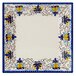 A white square melamine plate with a blue and yellow floral design.