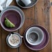 A table with plates and Libbey Englewood bowls stacked on it.