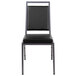 A Flash Furniture black vinyl banquet chair with metal legs.