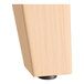 A wooden block with a wooden leg for a Lancaster Table & Seating bar height table base.