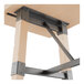 A Lancaster Table & Seating industrial trestle table base with wood and metal accents.