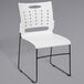 A white Flash Furniture stack chair with black legs.