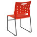 A Flash Furniture Hercules orange stack chair with black legs.