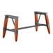 A Lancaster Table & Seating industrial trestle table base with a metal finish and wooden legs.