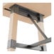 A Lancaster Table & Seating industrial table trestle base with a metal frame and bleached oak finish wood legs.