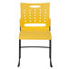 A yellow Flash Furniture stack chair with black legs.