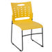 A yellow Flash Furniture stack chair with black legs.