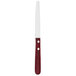 A Walco stainless steel steak knife with a serrated round tip and a red Polywood handle.