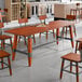 A Lancaster Table & Seating mahogany trestle table base with metal legs.