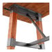 A Lancaster Table & Seating industrial wooden trestle table base with metal legs.