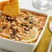 A bowl of dried navy beans with a slice of bread on top.