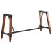 A Lancaster Table & Seating wooden trestle table base with metal legs.