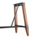 A Lancaster Table & Seating wooden table trestle with metal accents.