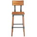 A Lancaster Table & Seating rustic industrial bar height chair with a wooden seat and metal frame.