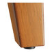 The trestle base of a Lancaster Table & Seating solid wood table with a rustic walnut finish.