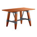 A Lancaster Table & Seating wooden table with trestle legs.