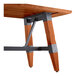 A Lancaster Table & Seating wooden table with a trestle base with metal accents.